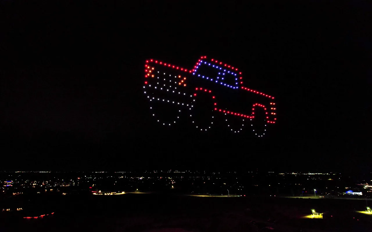 A drone light show forms a pickup truck above the town lights at night. Immersion produces drone light shows in Crested Butte, Colorado.