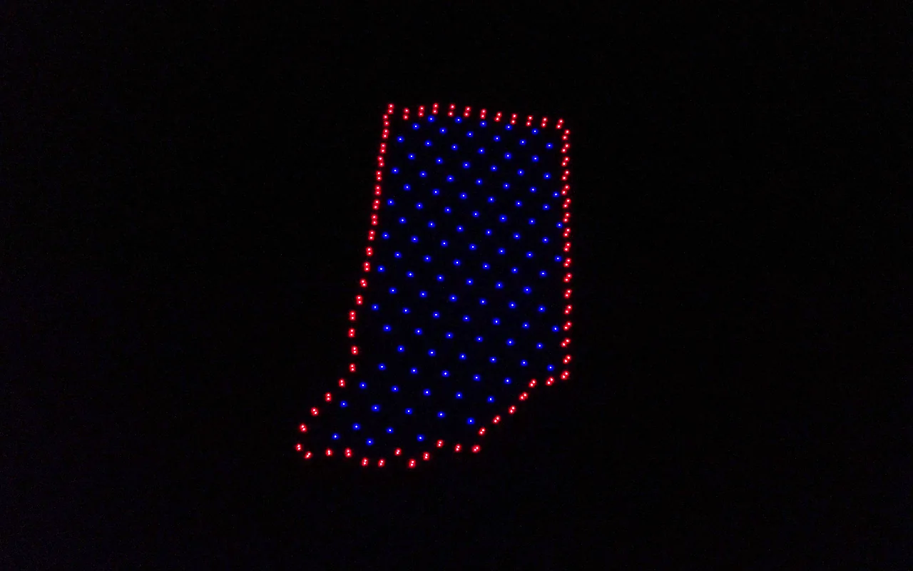 A drone light show forms the outline of Indiana filled in blue with a red border. Immersion produces drone light shows in Indianapolis, Indiana.