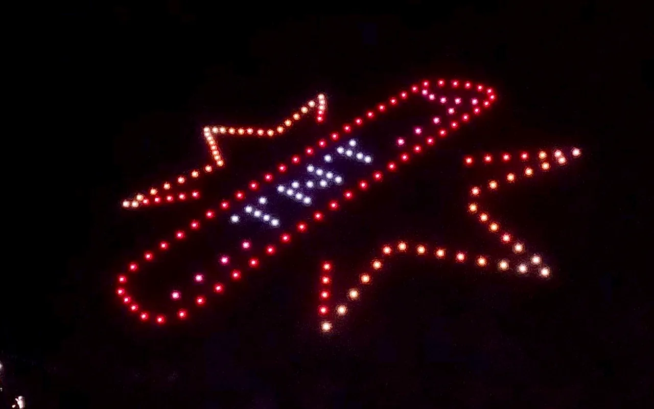 A drone light show forms a stick of TNT in red, white and blue at night. Immersion produces drone light shows in Winter Park, Colorado.